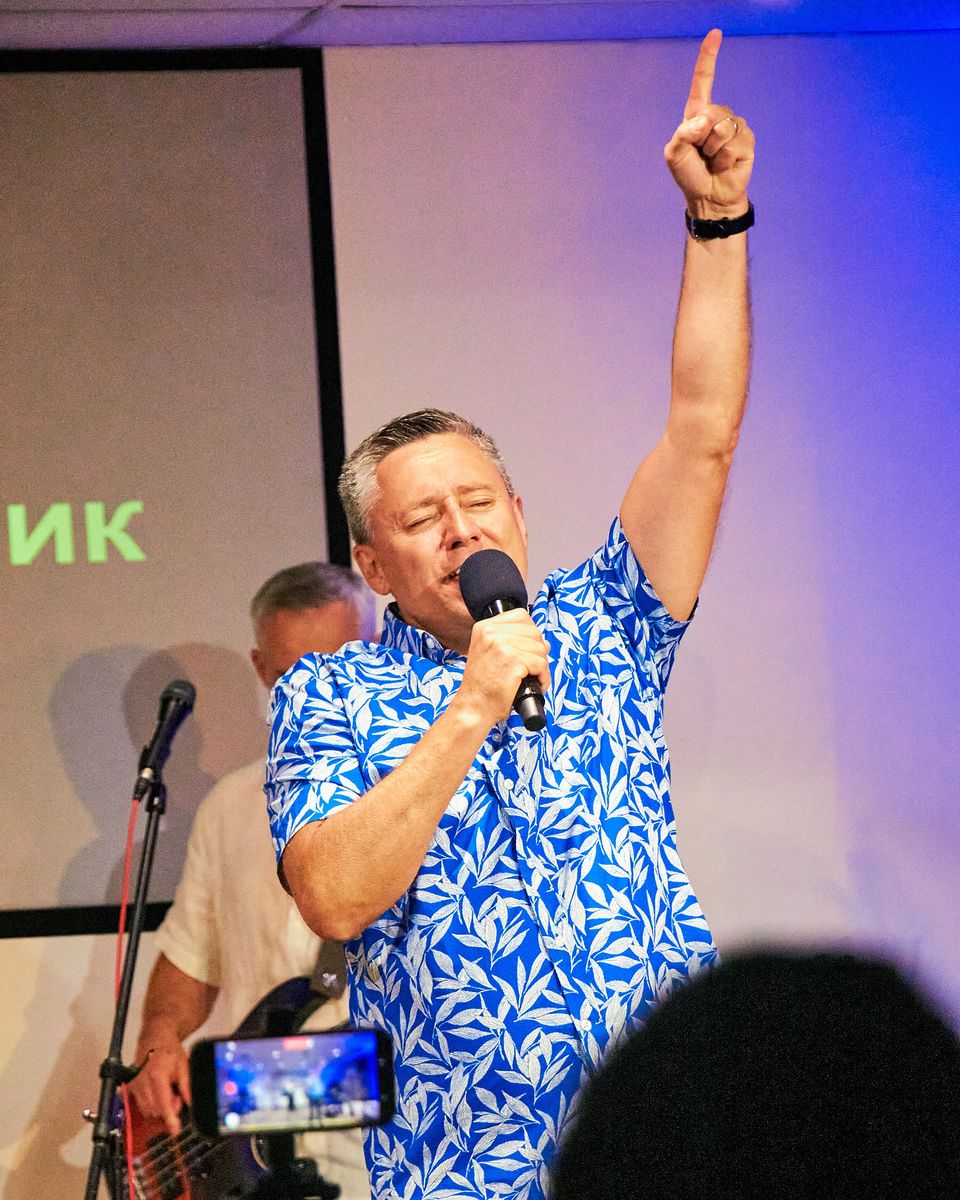 Pastor Ruslan Murin singing into a microphone